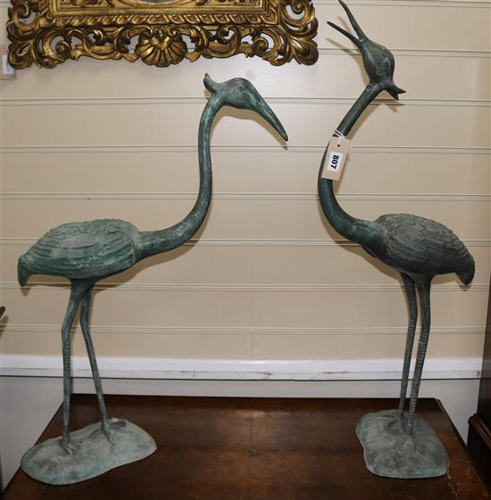 A pair of Asian bronze models of standing cranes, largest 80cm